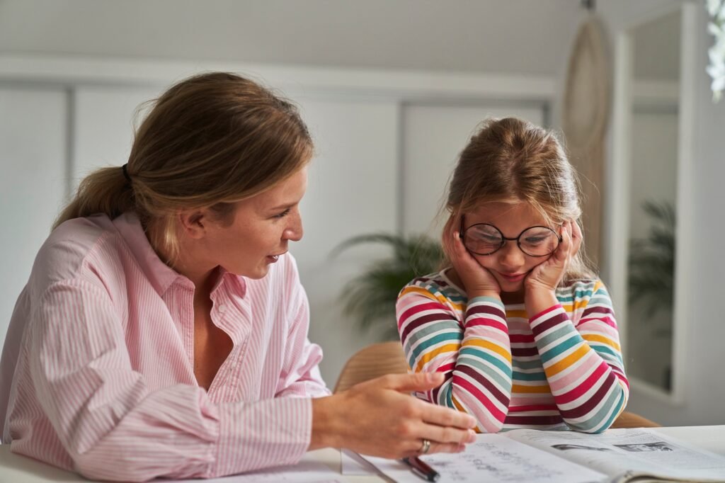 Distracted girl learning at home with her mother