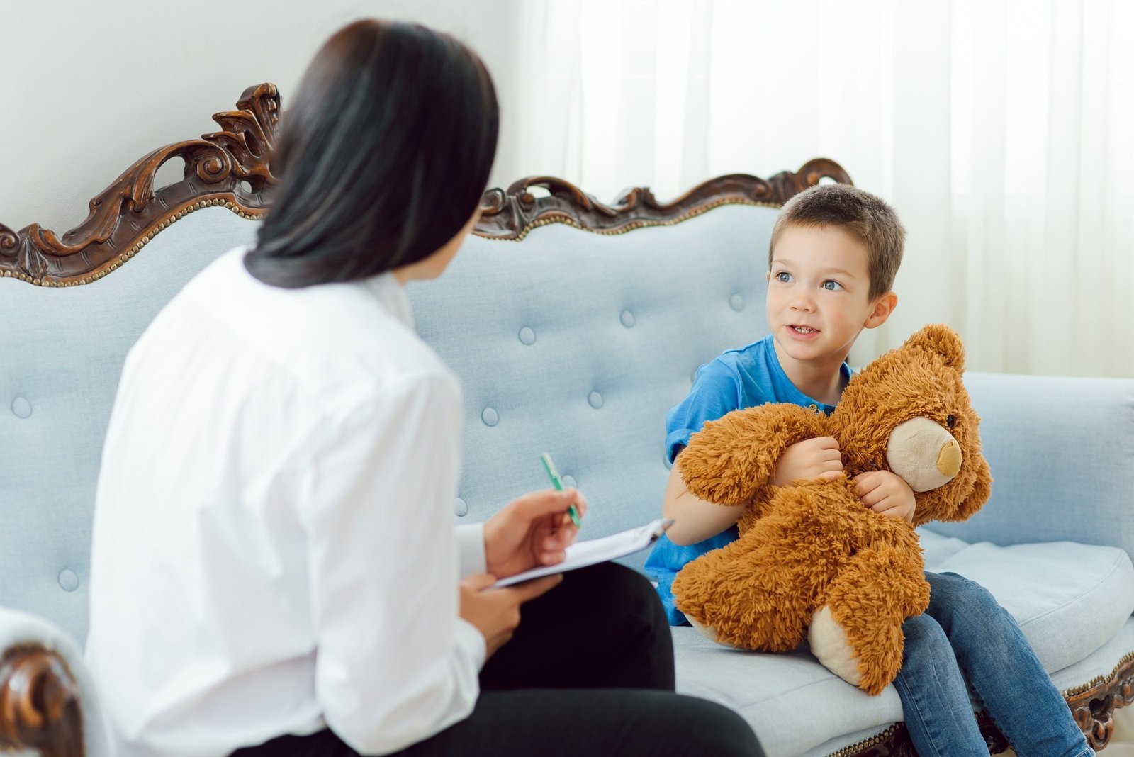 Picture of child psychologist working with young boy in office